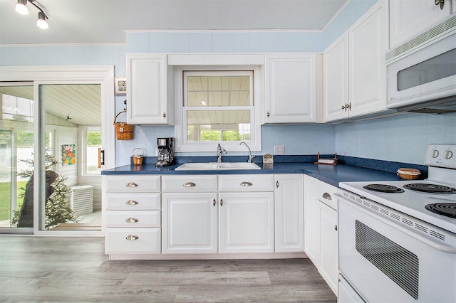 7394 N Keating Dr, Walkerville, MI 49459 - kitchen with white appliances, a sink, dark countertops, crown molding, and white cabinets