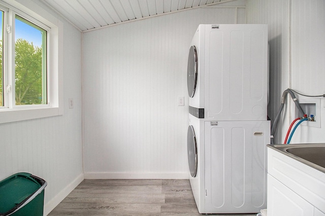 7394 N Keating Dr, Walkerville, MI 49459 - washroom with stacked washer / drying machine, light wood-style flooring, and baseboards