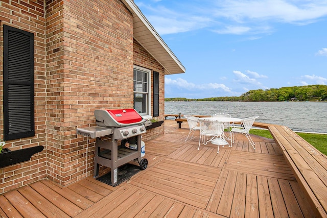 7394 N Keating Dr, Walkerville, MI 49459 - wooden deck featuring a water view, outdoor dining area, and a grill