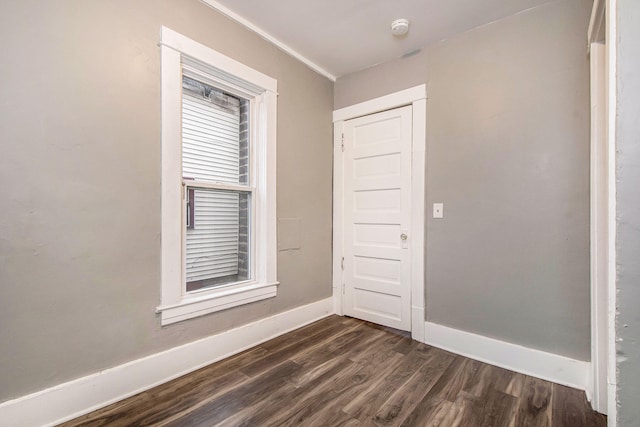 407 11th St NW Unit 409, Grand Rapids, MI 49504 - unfurnished room with dark wood finished floors, baseboards, and a smoke detector