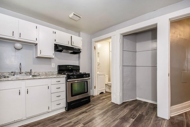 407 11th St NW Unit 409, Grand Rapids, MI 49504 - kitchen featuring under cabinet range hood, gas range, a sink, dark wood-style flooring, and white cabinets