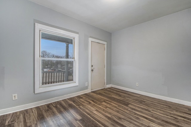 407 11th St NW Unit 409, Grand Rapids, MI 49504 - spare room featuring baseboards and dark wood-style floors
