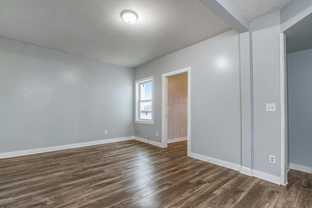 407 11th St NW Unit 409, Grand Rapids, MI 49504 - spare room featuring dark wood finished floors and baseboards