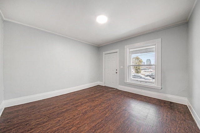 407 11th St NW Unit 409, Grand Rapids, MI 49504 - unfurnished room with crown molding, baseboards, and dark wood-type flooring
