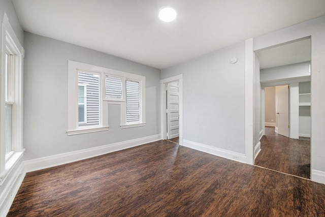 407 11th St NW Unit 409, Grand Rapids, MI 49504 - unfurnished bedroom with wood finished floors and baseboards