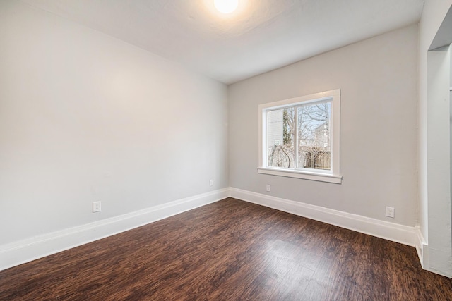 407 11th St NW Unit 409, Grand Rapids, MI 49504 - spare room with baseboards and dark wood-type flooring