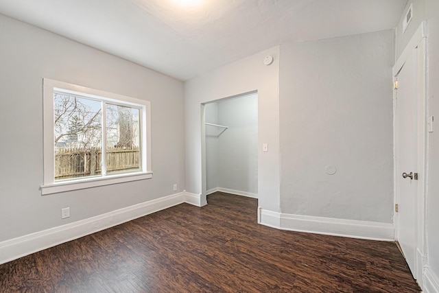 407 11th St NW Unit 409, Grand Rapids, MI 49504 - unfurnished bedroom with dark wood-style floors, baseboards, and a closet
