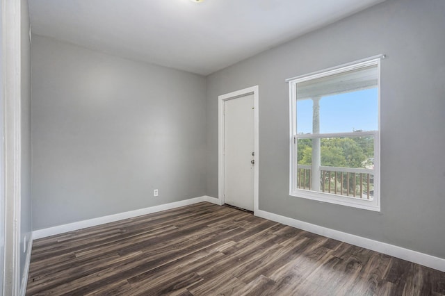 407 11th St NW Unit 409, Grand Rapids, MI 49504 - spare room with baseboards and dark wood-style floors