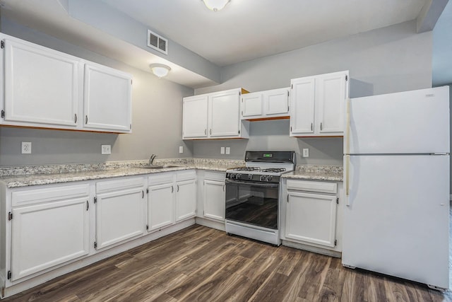 407 11th St NW Unit 409, Grand Rapids, MI 49504 - kitchen featuring freestanding refrigerator, gas range, a sink, and white cabinetry