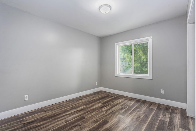 407 11th St NW Unit 409, Grand Rapids, MI 49504 - spare room with dark wood-type flooring and baseboards