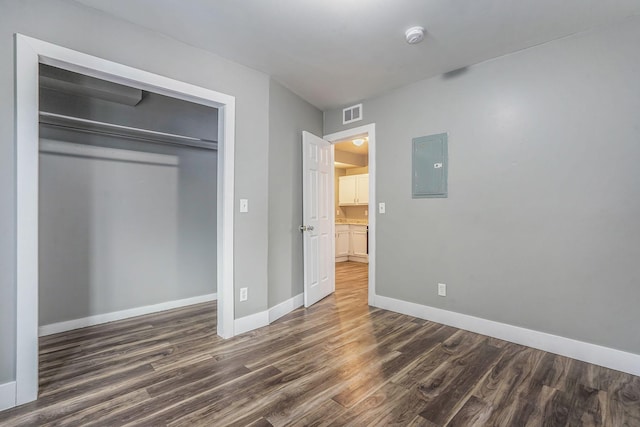407 11th St NW Unit 409, Grand Rapids, MI 49504 - unfurnished bedroom with electric panel, wood finished floors, baseboards, and a closet