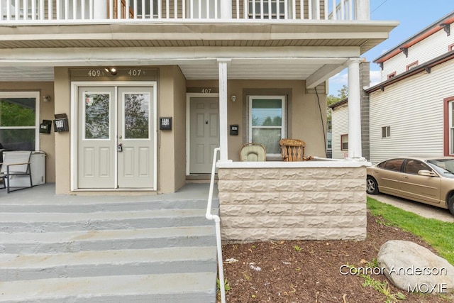 407 11th St NW Unit 409, Grand Rapids, MI 49504 - doorway to property with a porch and stucco siding