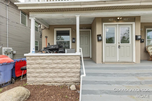 407 11th St NW Unit 409, Grand Rapids, MI 49504 - entrance to property with stucco siding and covered porch