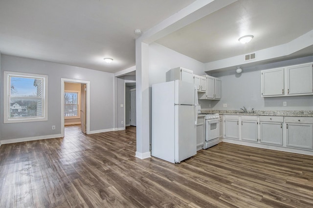 407 11th St NW Unit 409, Grand Rapids, MI 49504 - kitchen featuring white appliances, dark wood-type flooring, baseboards, open floor plan, and a sink