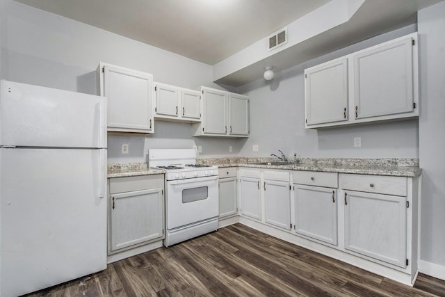 407 11th St NW Unit 409, Grand Rapids, MI 49504 - kitchen with white appliances, dark wood-style floors, a sink, and white cabinetry