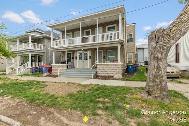 407 11th St NW Unit 409, Grand Rapids, MI 49504 - townhome / multi-family property with a balcony and covered porch