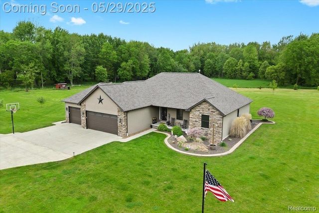 6035 Beard Rd, Byron, MI 48418 - view of front of property with stone siding, a front lawn, and an attached garage