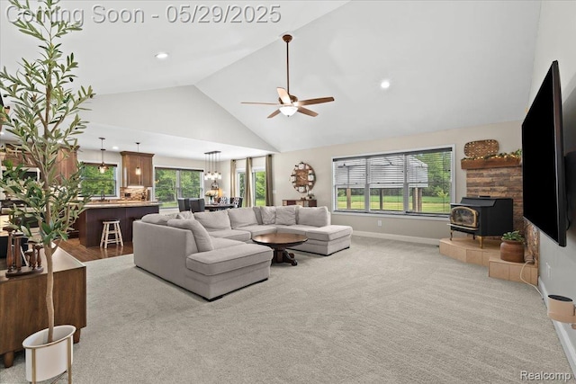 6035 Beard Rd, Byron, MI 48418 - carpeted living room featuring a wood stove, high vaulted ceiling, a ceiling fan, baseboards, and recessed lighting