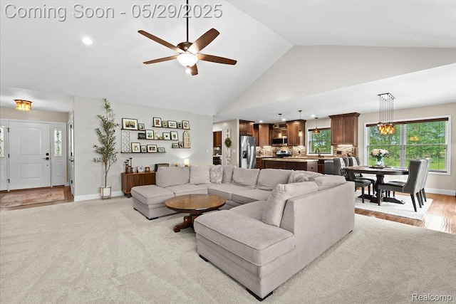6035 Beard Rd, Byron, MI 48418 - living room featuring a ceiling fan, high vaulted ceiling, and baseboards