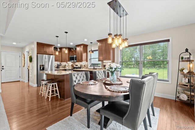 6035 Beard Rd, Byron, MI 48418 - dining space featuring wood finished floors, baseboards, recessed lighting, and a chandelier