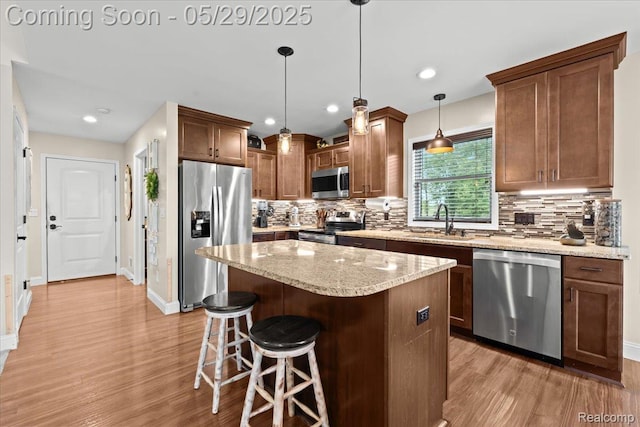 6035 Beard Rd, Byron, MI 48418 - kitchen with stainless steel appliances, light wood-type flooring, tasteful backsplash, baseboards, and recessed lighting