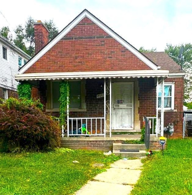 8603 Whitcomb St, Detroit, MI 48228 - bungalow-style home featuring brick siding, a chimney, a front lawn, and covered porch