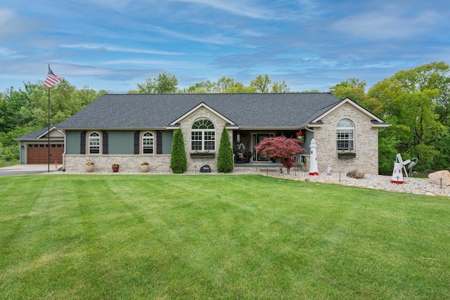 2363 Sundance Rdg, Howell, MI 48843 - ranch-style house featuring brick siding, a front yard, driveway, and a shingled roof