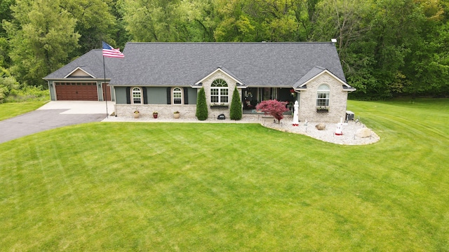 2363 Sundance Rdg, Howell, MI 48843 - ranch-style house featuring asphalt driveway, a front lawn, a garage, and roof with shingles