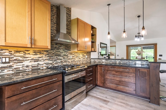 2363 Sundance Rdg, Howell, MI 48843 - kitchen featuring wall chimney range hood, gas stove, vaulted ceiling, a peninsula, and light wood finished floors