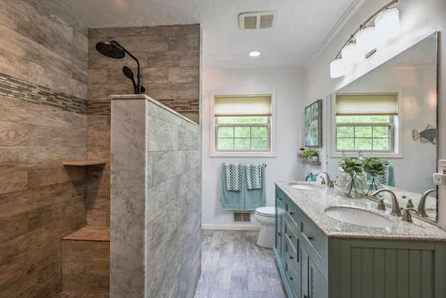 2363 Sundance Rdg, Howell, MI 48843 - bathroom featuring plenty of natural light, a walk in shower, toilet, crown molding, and double vanity