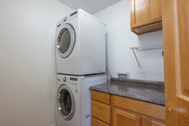 2363 Sundance Rdg, Howell, MI 48843 - laundry area with stacked washer / drying machine and cabinet space