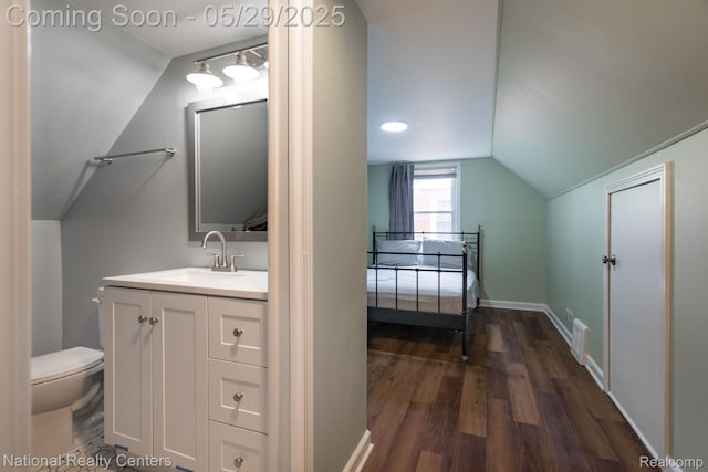 3027 Ferris Ave, Royal Oak, MI 48073 - bathroom with lofted ceiling, vanity, toilet, wood finished floors, and baseboards