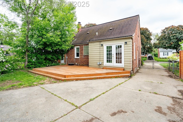 3027 Ferris Ave, Royal Oak, MI 48073 - rear view of house with french doors, a deck, brick siding, roof with shingles, and a chimney