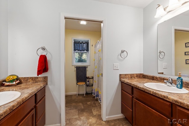 10623 Springville Hwy, Onsted, MI 49265 - full bath featuring two vanities, baseboards, stone finish flooring, and a shower with shower curtain