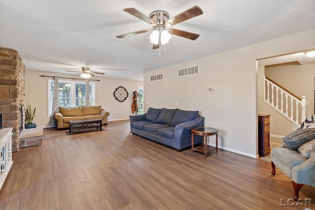 10623 Springville Hwy, Onsted, MI 49265 - living area with a ceiling fan, stairs, wood finished floors, baseboards, and a textured ceiling