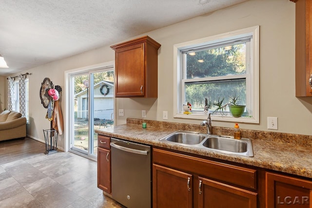 10623 Springville Hwy, Onsted, MI 49265 - kitchen featuring dishwasher, a sink, brown cabinets, and a textured ceiling