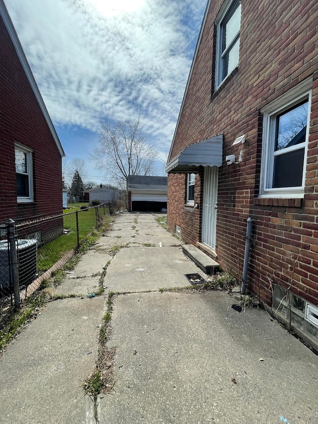 16500 Eastburn St, Detroit, MI 48205 - view of home's exterior with central air condition unit, brick siding, and driveway