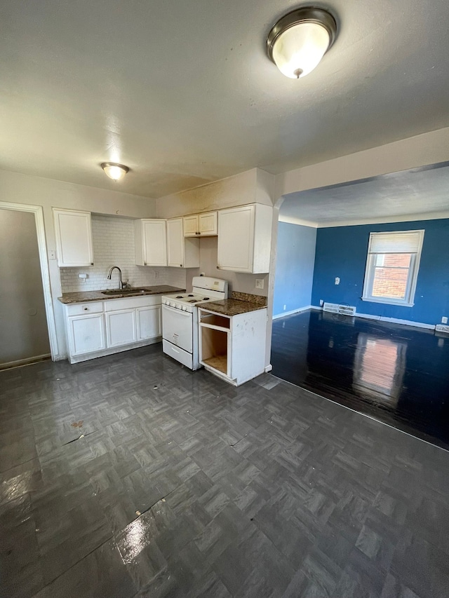 16500 Eastburn St, Detroit, MI 48205 - kitchen featuring white electric stove, a sink, white cabinetry, baseboards, and open floor plan