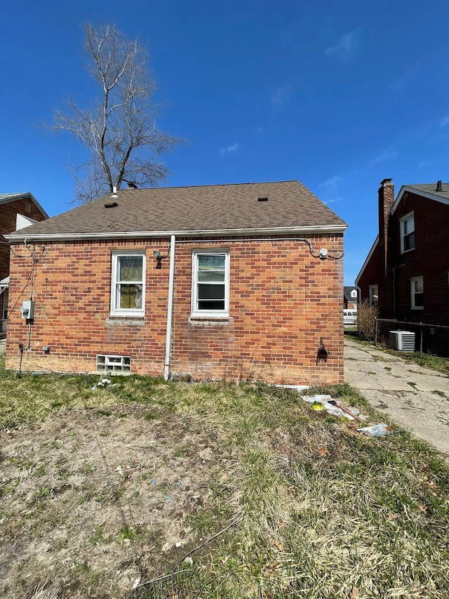 16500 Eastburn St, Detroit, MI 48205 - back of property featuring brick siding, roof with shingles, and central AC unit