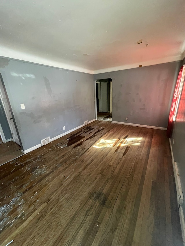 10952 Peerless St, Detroit, MI 48224 - unfurnished room featuring arched walkways, wood-type flooring, and baseboards