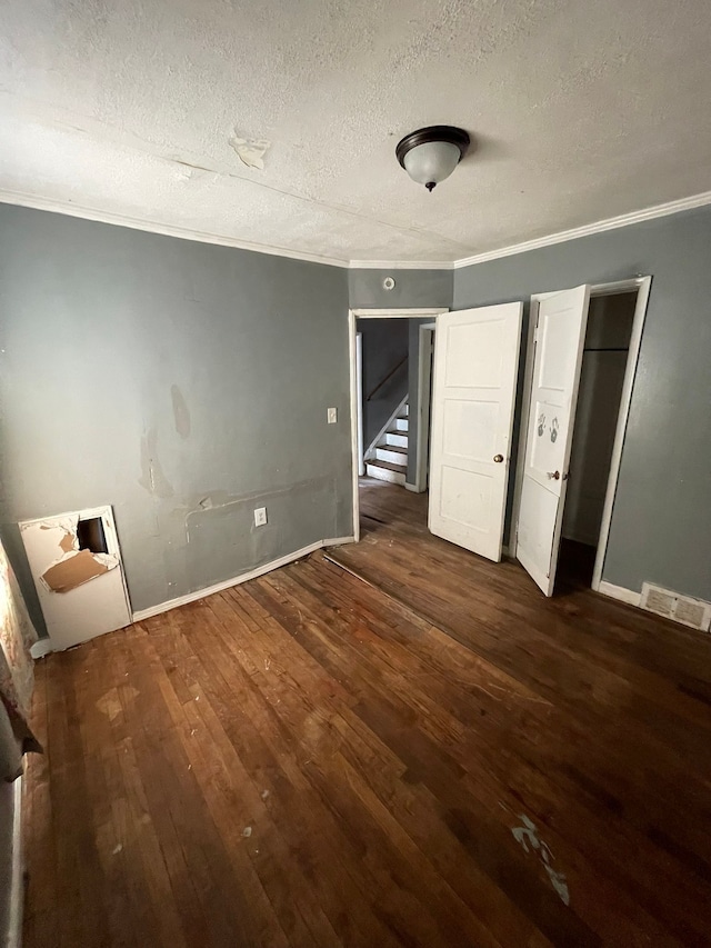 10952 Peerless St, Detroit, MI 48224 - unfurnished bedroom featuring a textured ceiling, hardwood / wood-style flooring, ornamental molding, and baseboards