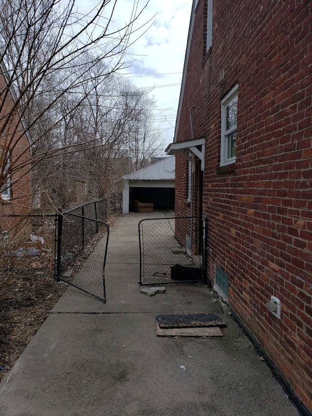 10952 Peerless St, Detroit, MI 48224 - view of home's exterior featuring brick siding and a gate