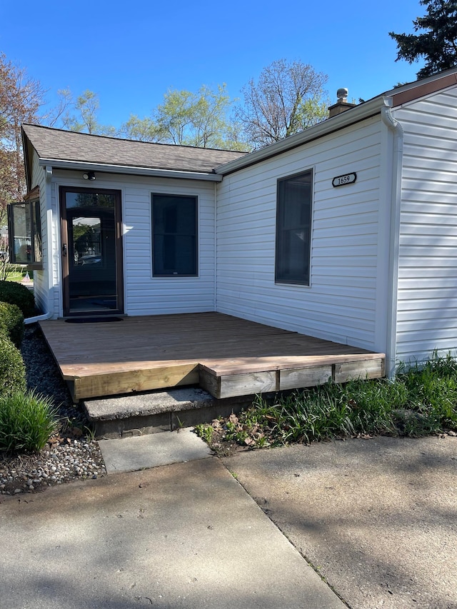 1659 Weymouth St, West Bloomfield, MI 48324 - back of property with a wooden deck, a chimney, and a shingled roof