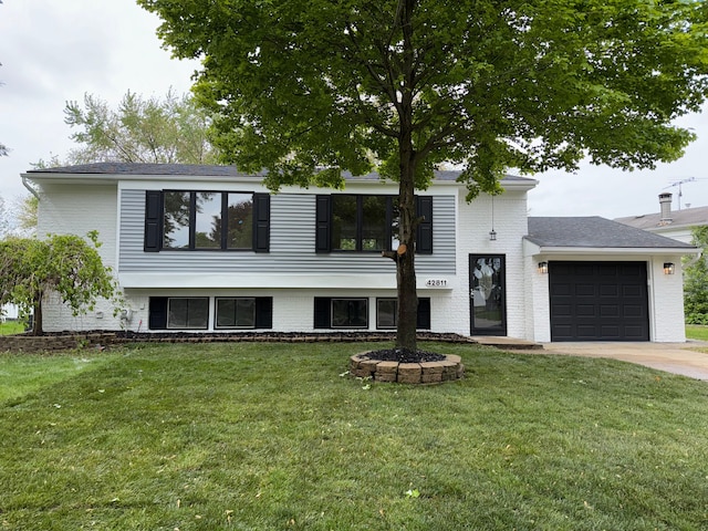 42811 Wilmington Dr, Sterling Heights, MI 48313 - view of front facade featuring an attached garage, driveway, and a front yard