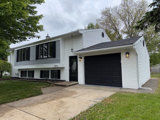 42811 Wilmington Dr, Sterling Heights, MI 48313 - split level home featuring driveway, brick siding, an attached garage, a front lawn, and a chimney