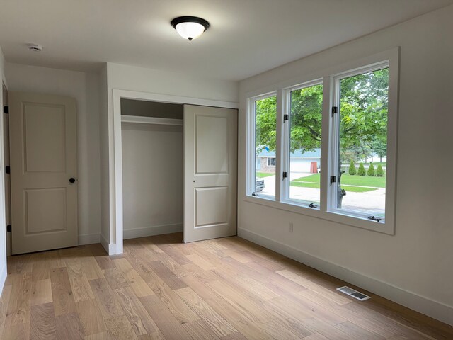 42811 Wilmington Dr, Sterling Heights, MI 48313 - unfurnished bedroom featuring baseboards, a closet, and light wood-style floors