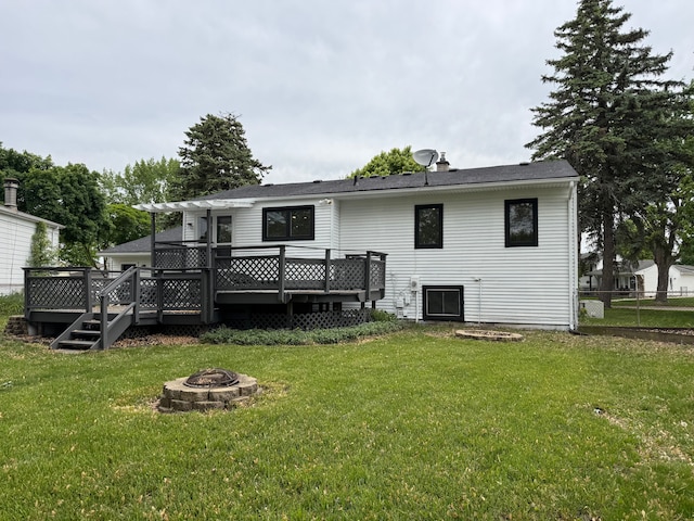 42811 Wilmington Dr, Sterling Heights, MI 48313 - rear view of house featuring an outdoor fire pit and a wooden deck