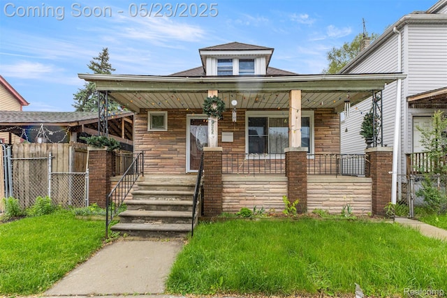 7295 Gartner St, Detroit, MI 48209 - view of front facade with covered porch, stone siding, and roof with shingles