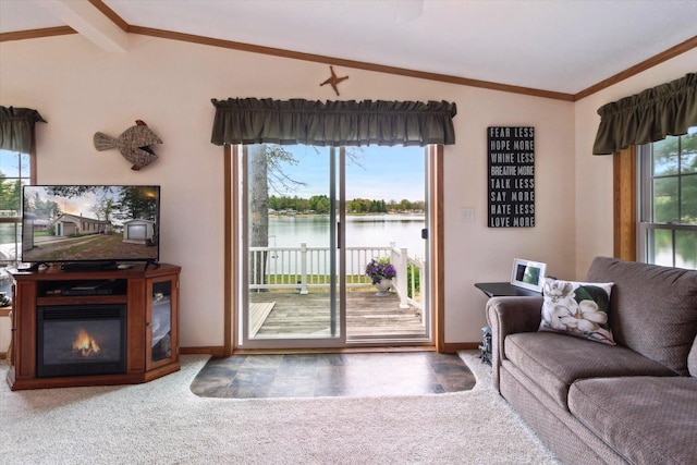 1797 Lawrence Dr, Bitely, MI 49309 - carpeted living room with vaulted ceiling, a water view, baseboards, a glass covered fireplace, and crown molding