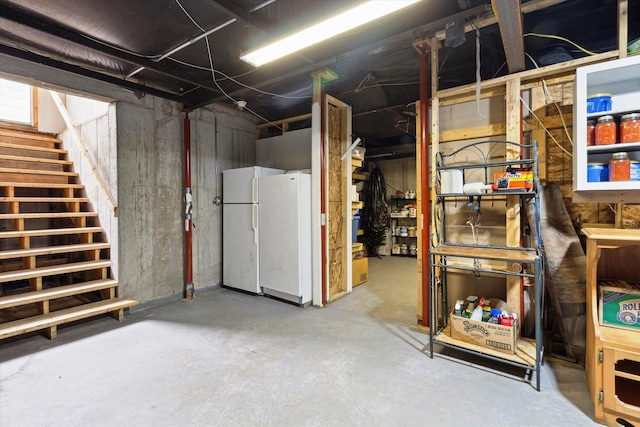 1797 Lawrence Dr, Bitely, MI 49309 - unfinished basement featuring freestanding refrigerator and stairway